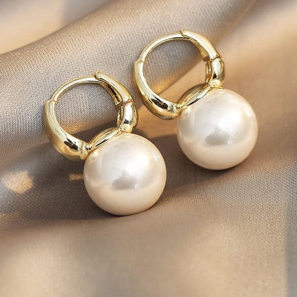 Large pearl drop earrings, fashion, femininity and elegance.